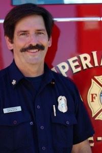 John French standing in front of a fire truck.