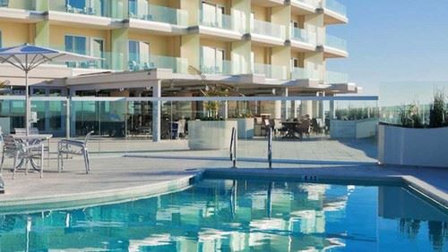 A pool surrounded by a glass wall at the Pier South Resort.